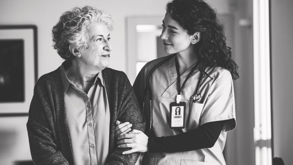 Caregiver with resident representing the Product of post-acute care: care